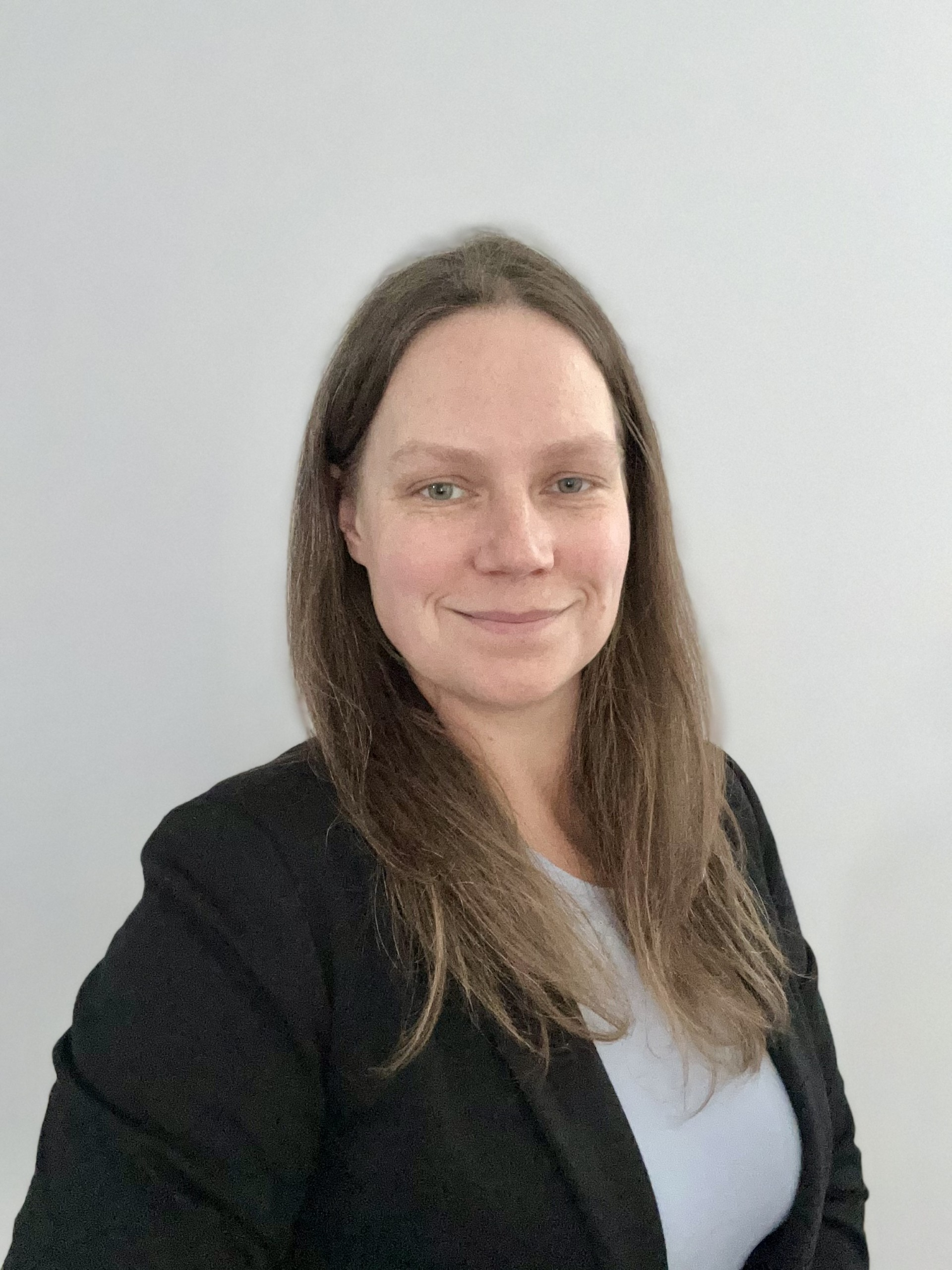 Portrait of Kelsey Annan, founder of Explain My Home, wearing a black blazer